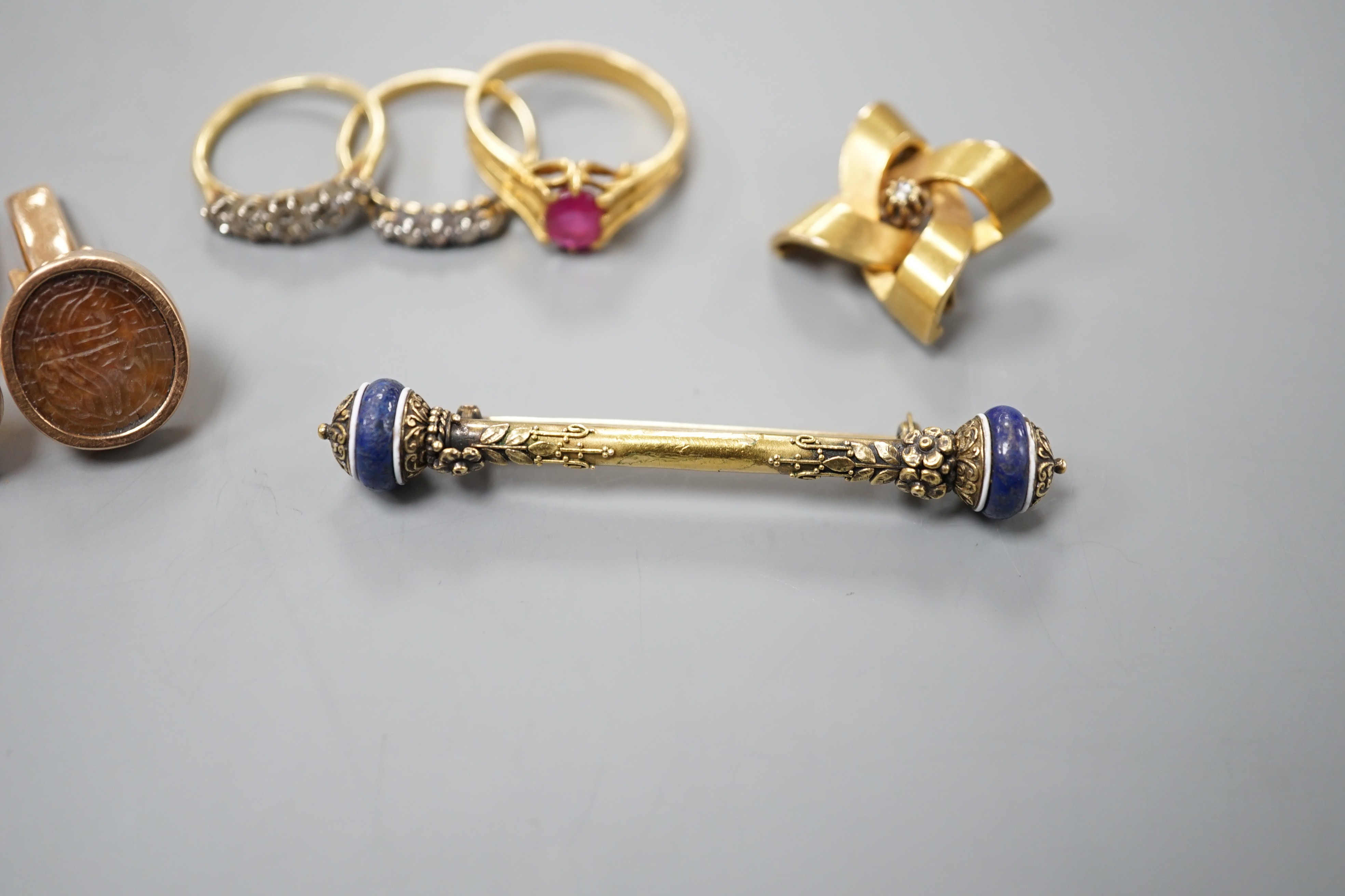 A group of mixed jewellery including two 18ct and diamond half hoop rings, a pair of Middle Eastern yellow metal and talismanic carnelian intaglio cufflinks, a yellow metal and diamond set brooch, a synthetic? ruby set y